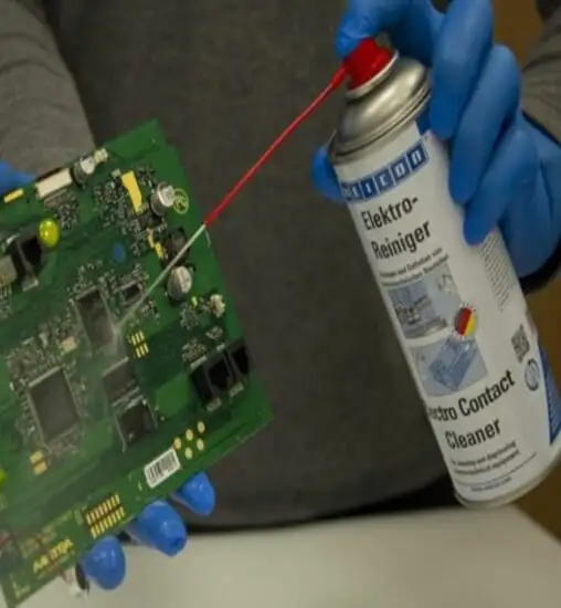 Процес очищення друкованої плати PCB від пилу за допомогою балона зі стиснутим повітрям у майстерні
